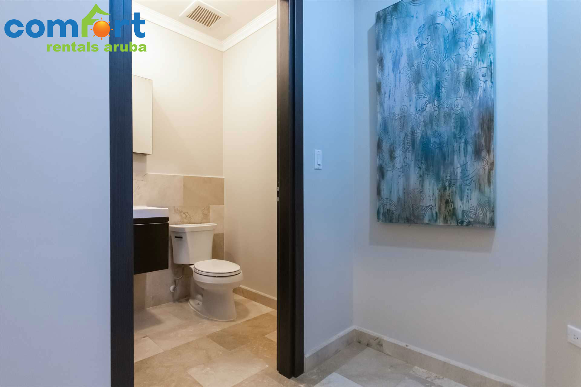 A half bathroom is conveniently located in the corridor
