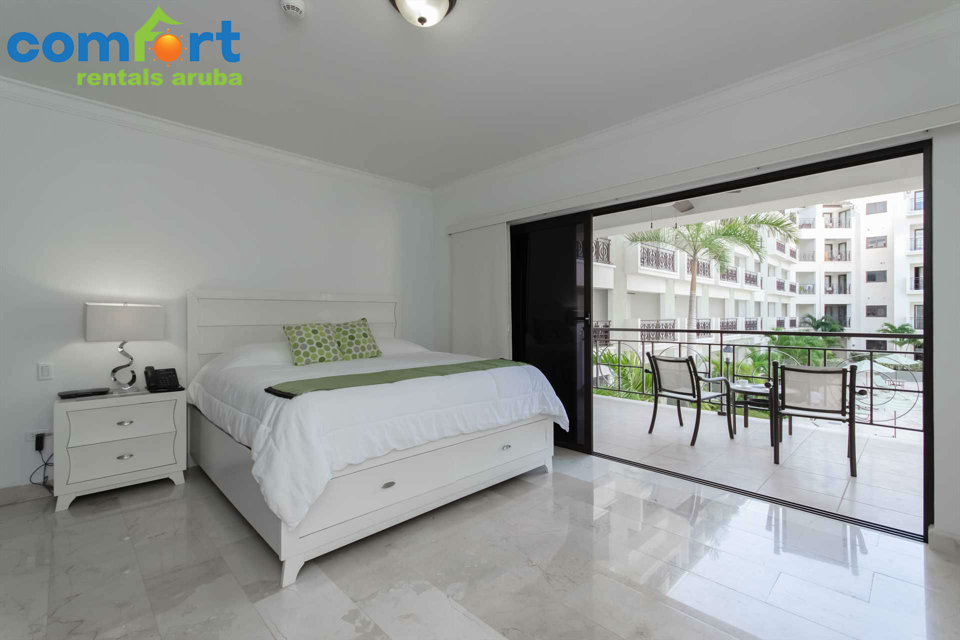 The master bedroom with a king-size bed and access to the balcony